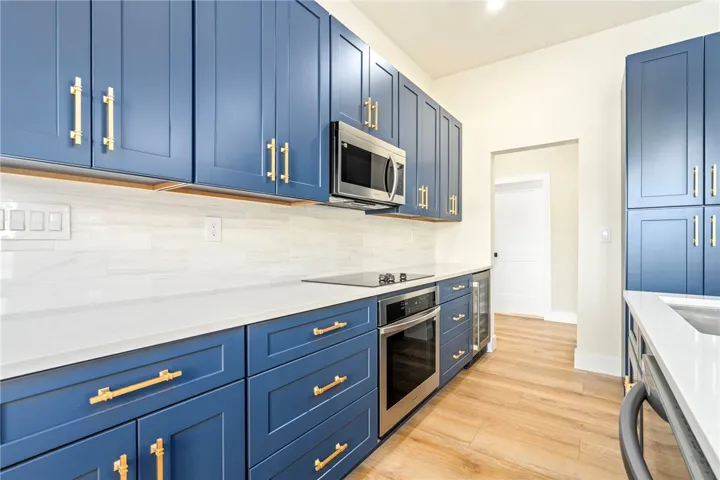 Gleaming stone countertops and custom cabinetry define this modern kitchen workspace.