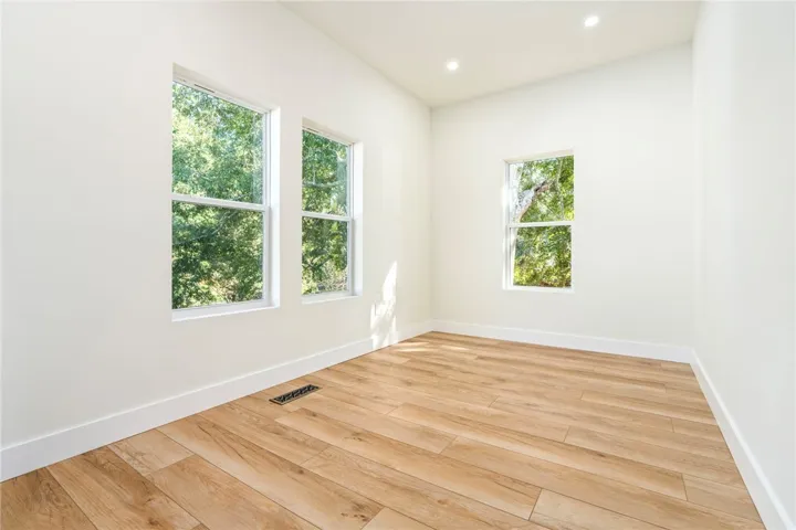 Crisp white walls and warm wood-style flooring create a serene, light-filled interior space.