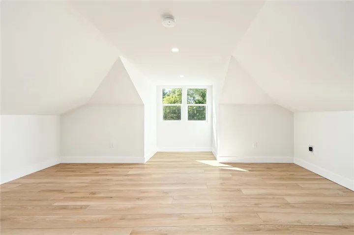 Slanted ceilings and wide-plank flooring define this versatile top-floor bonus space.