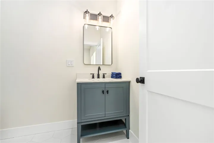 Clean lines and a modern vanity define this pristine powder room.
