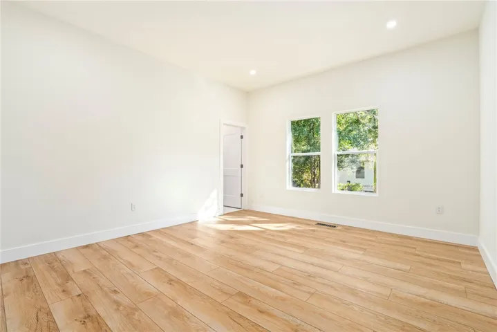 Gleaming wood-look floors and clean-lined windows define this versatile, airy interior space.