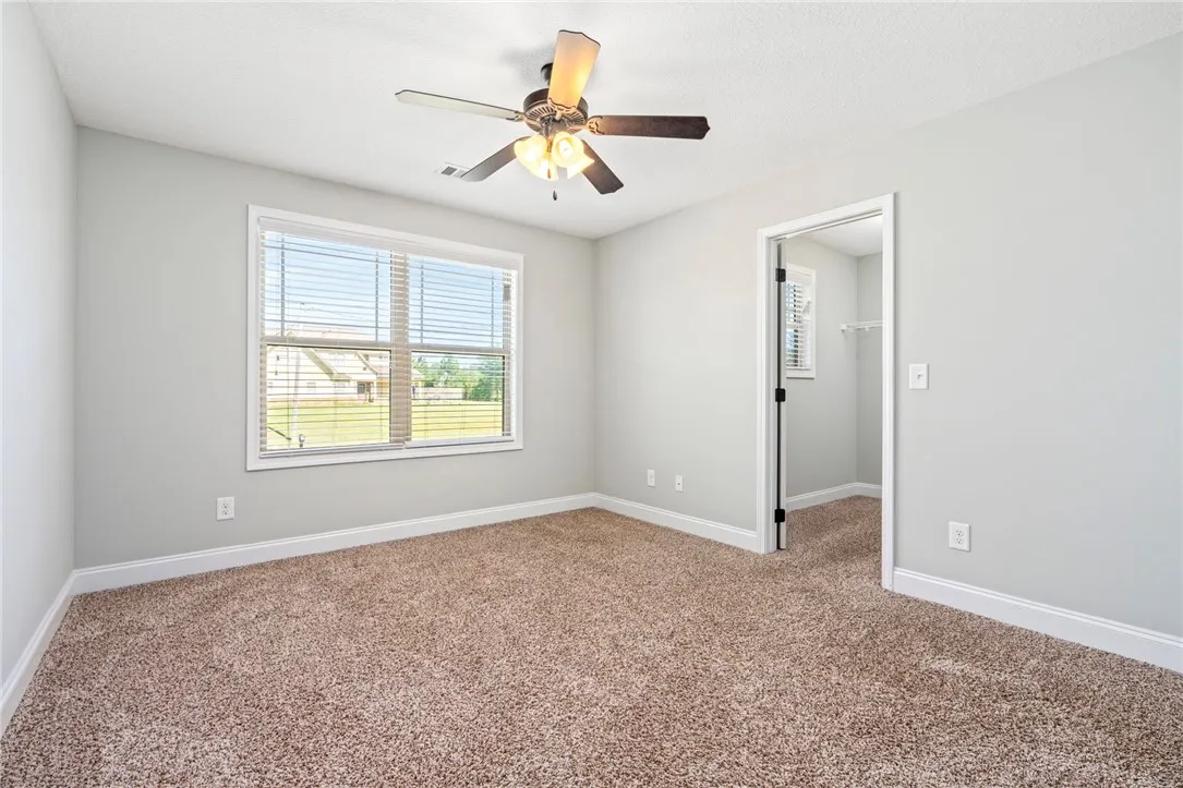 Plush carpeting and generous natural light define this comfortable secondary bedroom.