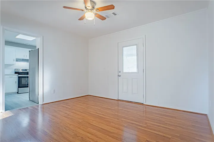 Gleaming wood floors anchor this versatile room offering convenient exterior access and nearby kitchen transition.