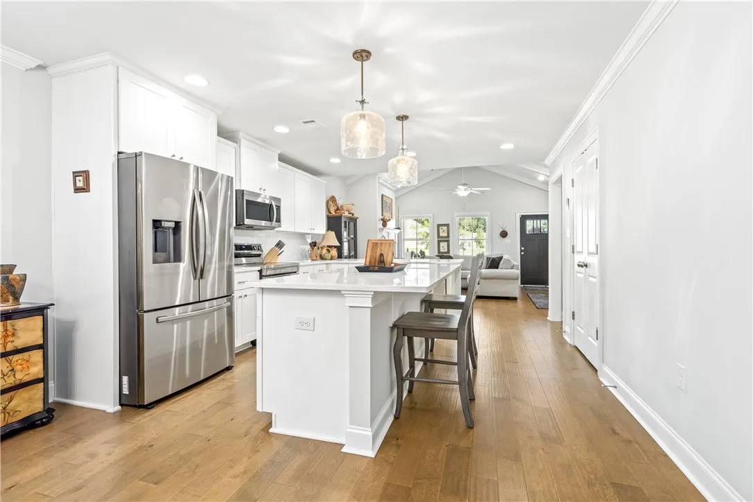 An open kitchen / living room / dining area layout makes it easy for everyone to move around and enjoy their time together.