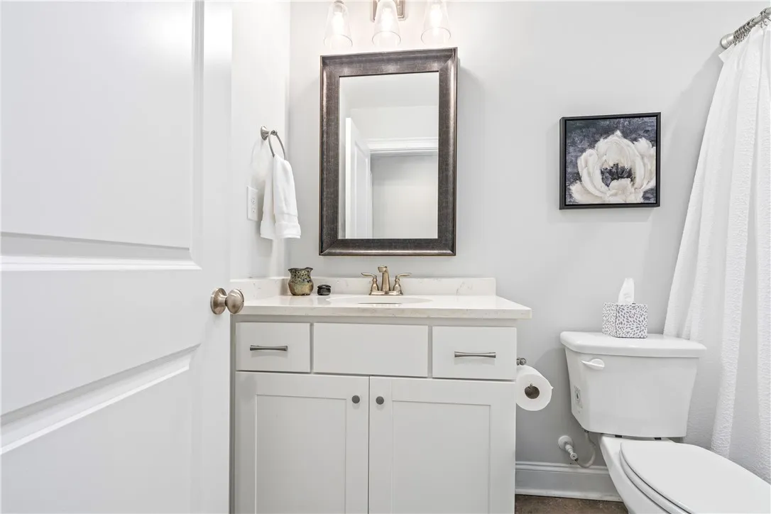 Clean lines and stone counters highlight this well-appointed guest bathroom