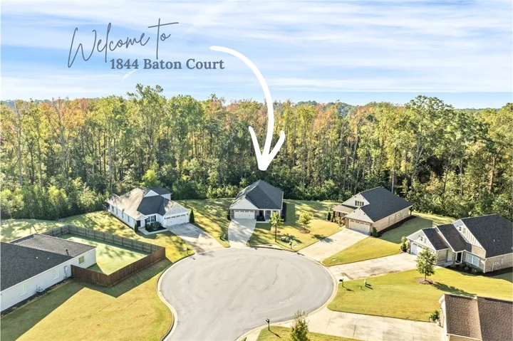An aerial perspective showcases a sweet suburban cul-de-sac bordered by mature trees.