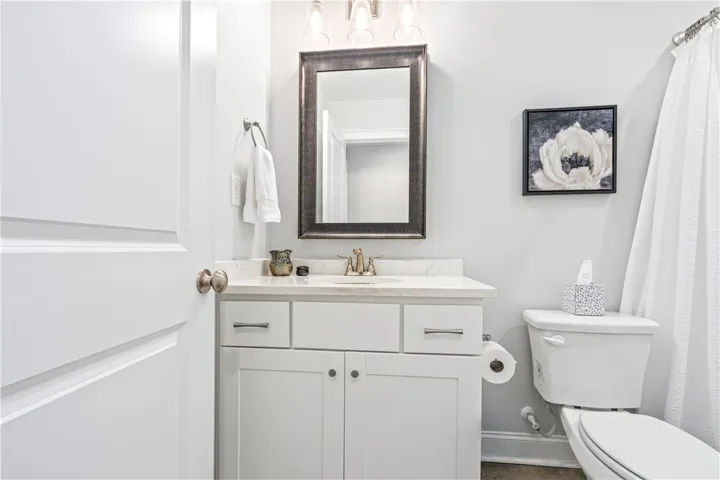 Clean lines and stone counters highlight this well-appointed guest bathroom