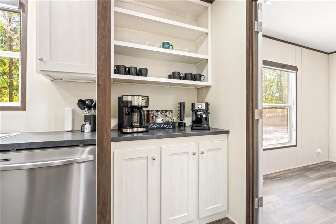 Custom cabinetry and built-in shelving define this functional beverage station.