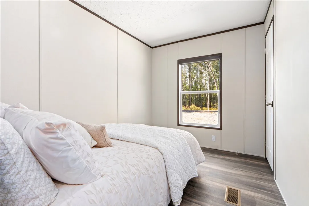 Wood-look flooring complements the simple lines of this quiet secondary bedroom.