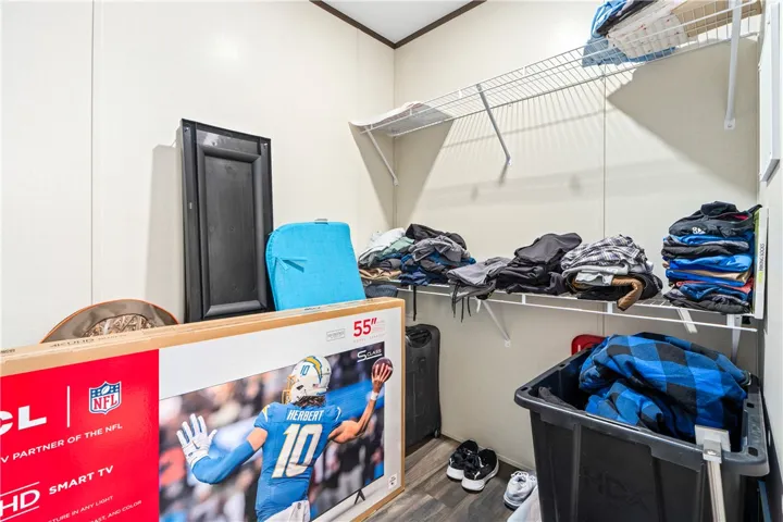 Functional storage space includes wire shelving and durable wood-look flooring.