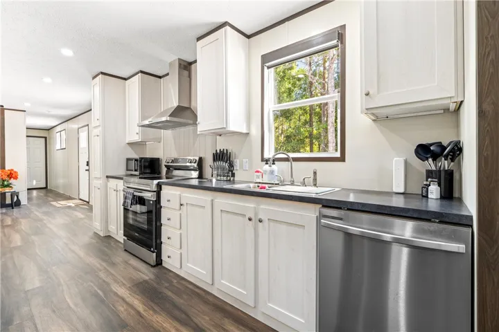 Streamlined cabinetry and modern appliances define this functional, open kitchen layout.