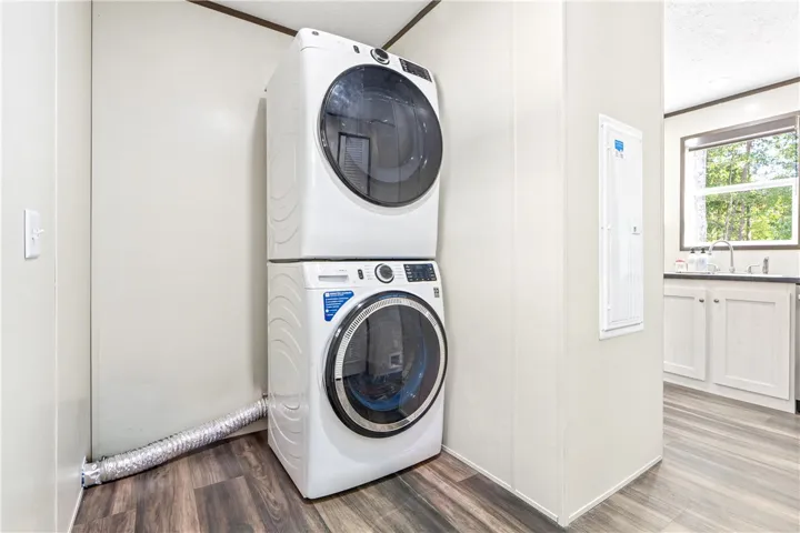 A dedicated home utility alcove features durable wood-look flooring and structured framing.