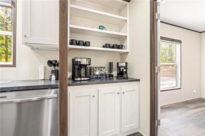 Custom cabinetry and built-in shelving define this functional beverage station.