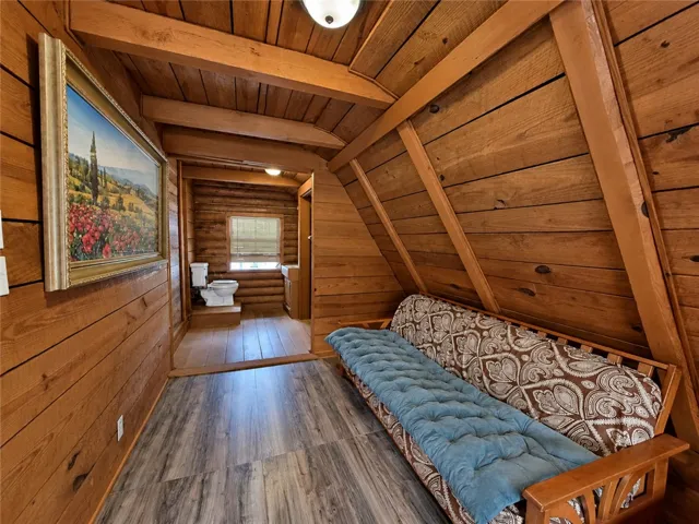 Rich wood planking covers the walls and vaulted ceiling of this rustic living space.