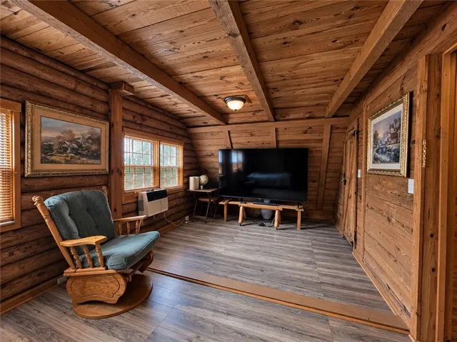 Rich wood planking on the walls and ceiling adds rustic warmth to this cozy space.
