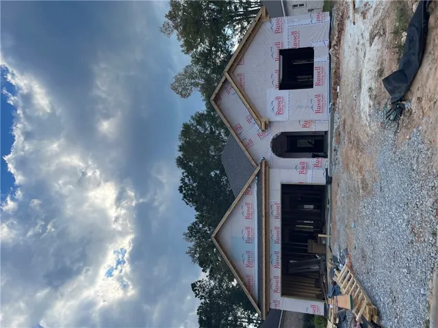 New residential construction in progress showcases classic gables and architectural framing against the sky.