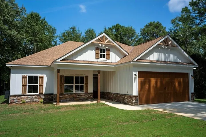 Board and batten siding pairs beautifully with stone accents on this modern craftsman exterior.