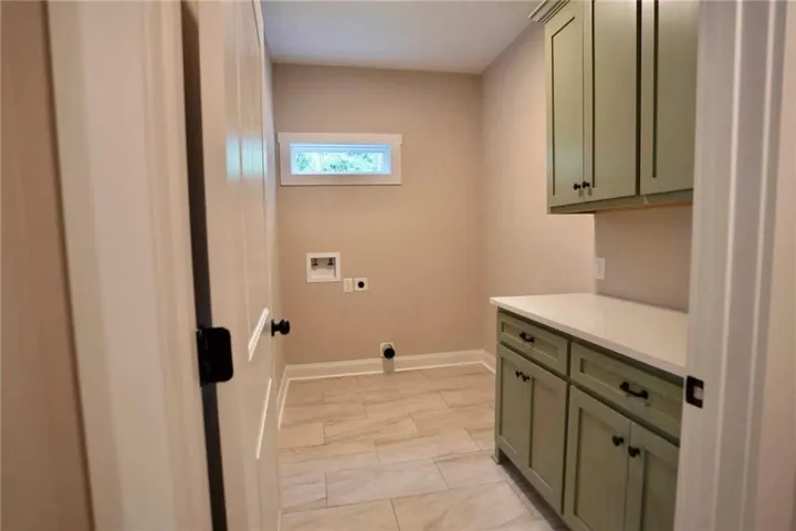 Functional workspace features built-in cabinetry, durable solid counters, and classic tile flooring.