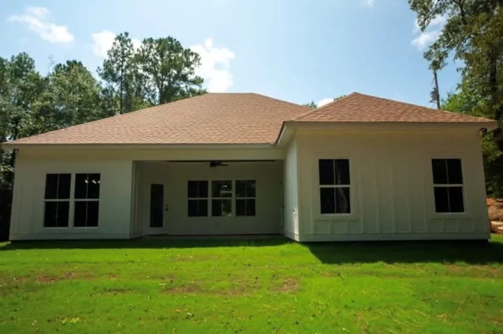 An inviting covered patio accents the rear facade of this newly constructed home.