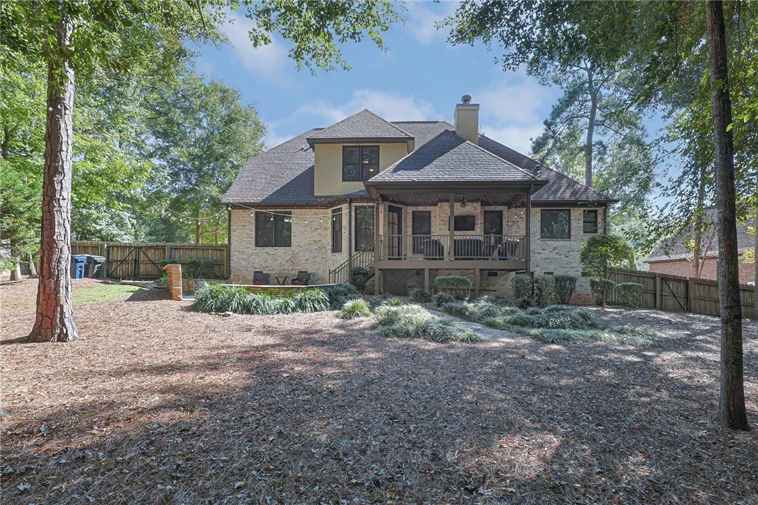 A spacious elevated deck overlooks the wooded yard of this brick multi-level home.