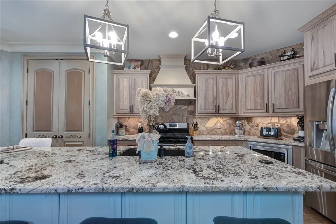 Custom cabinetry and premium stone counters define this masterfully crafted culinary space.