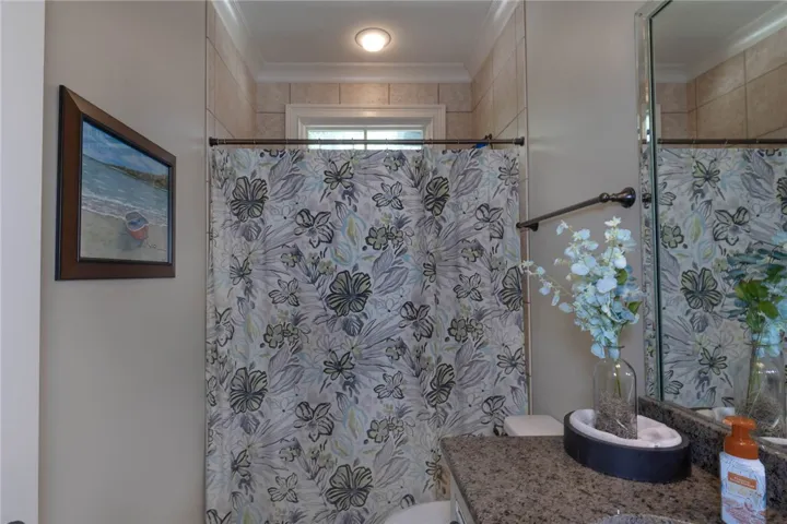 Crown molding and a granite countertop elevate this classic bathroom design.