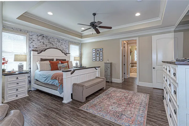 Crown molding details and warm wood flooring define this elegant main-level retreat.