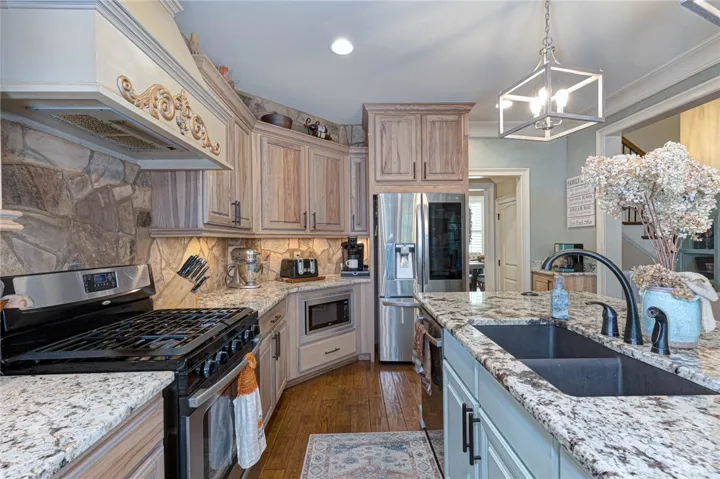 Fine woodwork and detailed stone accents define this thoughtfully designed culinary workspace.