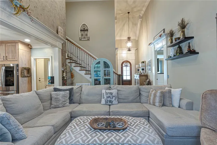 Hardwood floors and soaring ceilings create an airy atmosphere throughout the open layout.