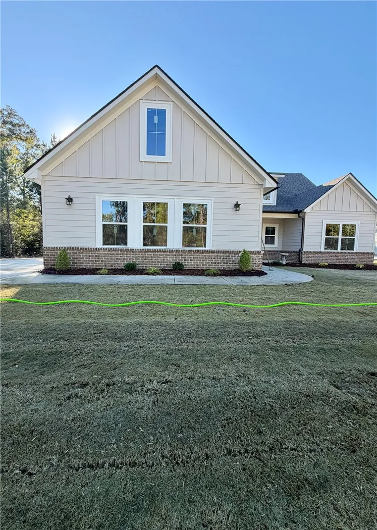 Symmetrical gables and timeless brick accents define this modern craftsman exterior design.