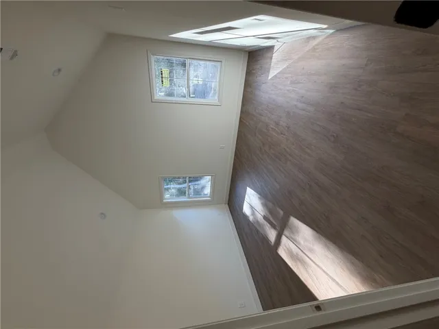 Angled ceilings and wood-style flooring define this versatile interior space.