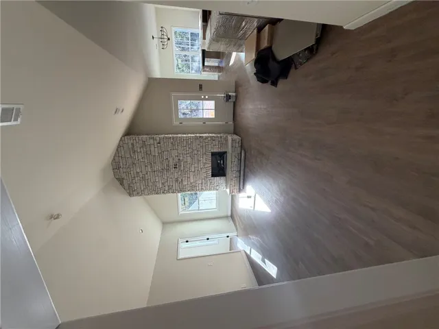 An impressive stone fireplace anchors the vaulted living space, complete with durable wood-look flooring.