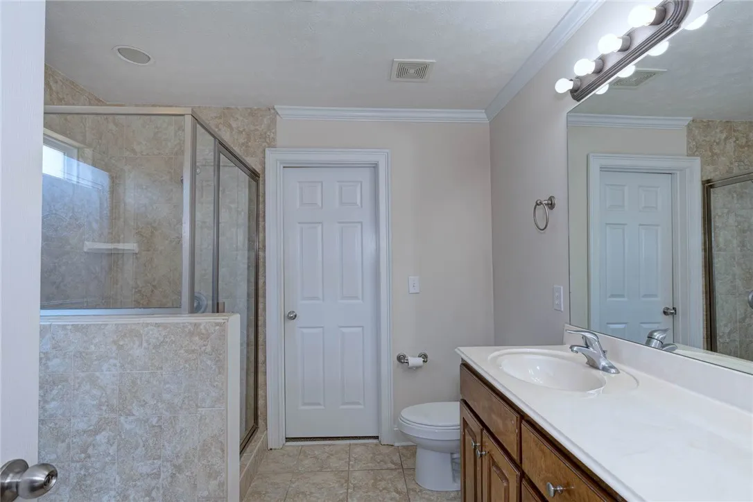 Crown molding and neutral tile flooring accentuate this tidy, functional layout.