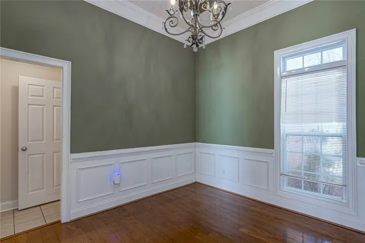Elegant wainscoting and polished hardwood flooring define this classic dining area.