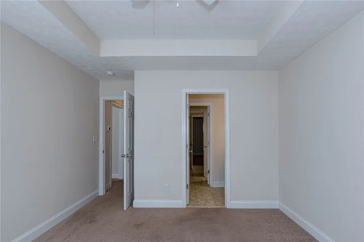 A classic tray ceiling and soft wall tones define this versatile space with comfortable carpeting.