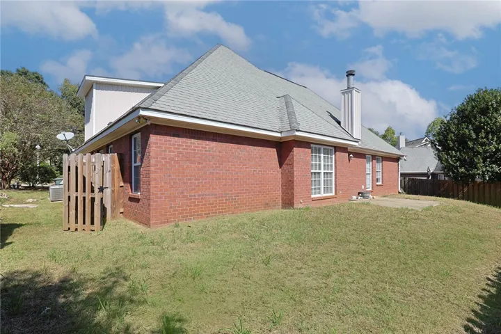 Classic brick exterior and high rooflines define the back of this traditional residence.