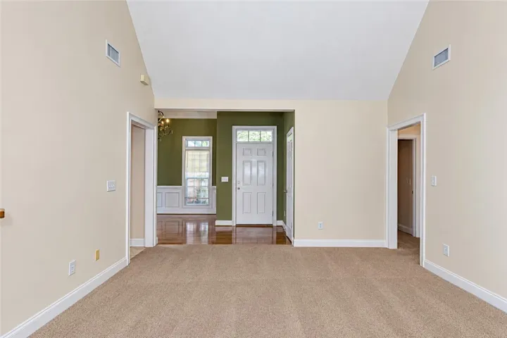Soaring vaulted ceilings and a classic open layout define this transition into the dining area.