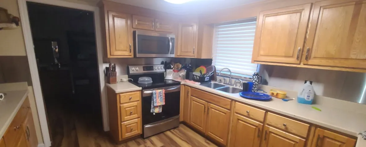 Classic wood cabinetry and durable finishes define this functional kitchen workspace.