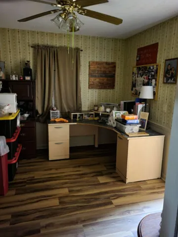 Rich wood plank flooring sets a warm foundation in this versatile workspace.