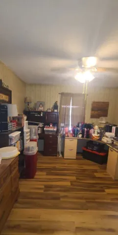 Warm wood flooring defines this versatile space ready for customization.
