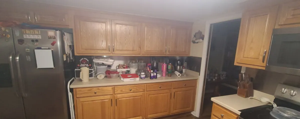 Warm oak cabinetry pairs with stainless steel appliances in this functional workspace.