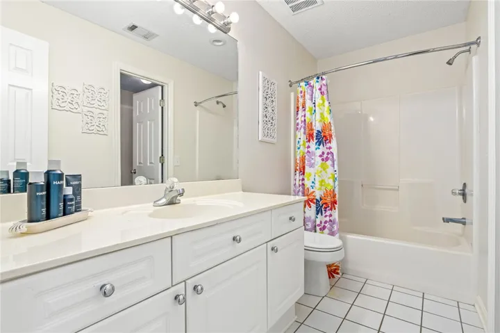Clean lines and classic tiling define this functional, well-maintained bathroom space.