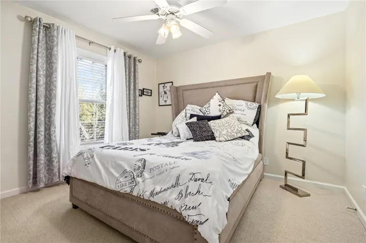 Soft carpeting and generous natural light define this cozy, restful private space.
