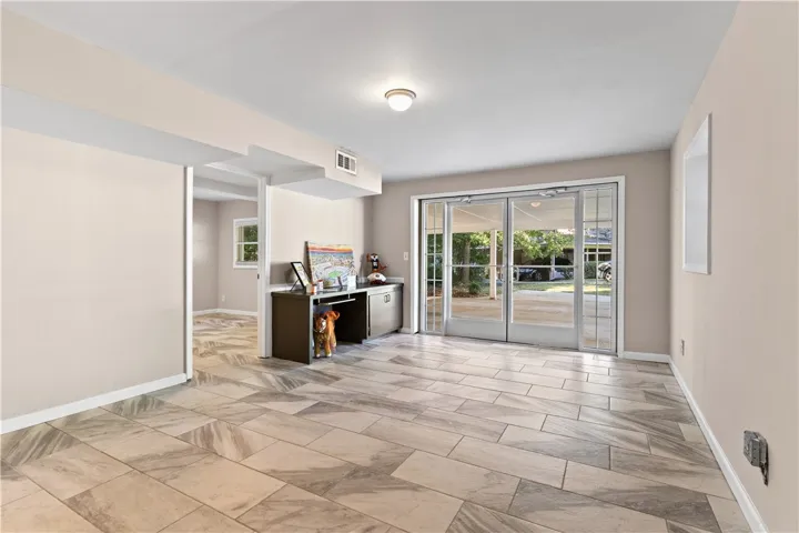 Gleaming tile floors and wide glass doors define this versatile lower level space.