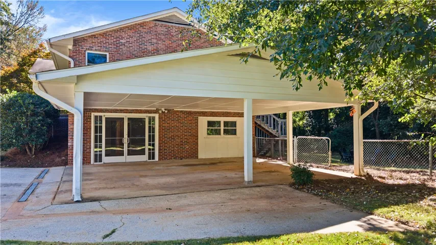 A spacious covered carport integrates seamlessly with the brick exterior of this multi-level home.