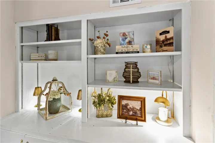 Custom built-in shelving provides abundant display space and integrated accent lighting.
