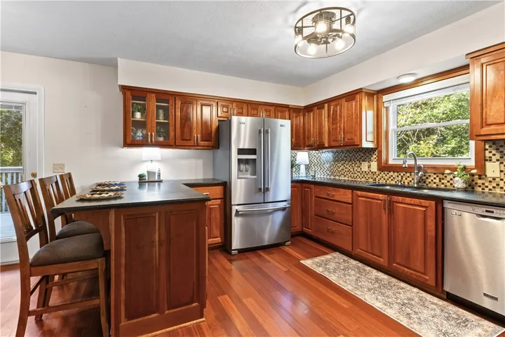 Rich wood cabinetry paired with classic countertops highlights a warm, functional culinary workspace.