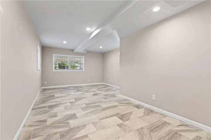 Recessed lighting and modern tile flooring define this versatile finished lower level living space.