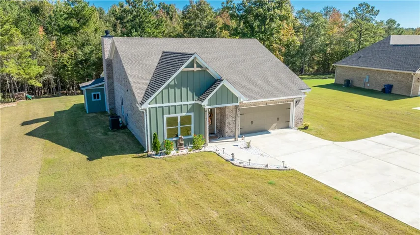 Board and batten accents pair with brick siding under a classic gabled roofline.
