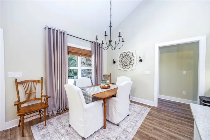 A vaulted ceiling and rich hardwood flooring define this welcoming dining area.